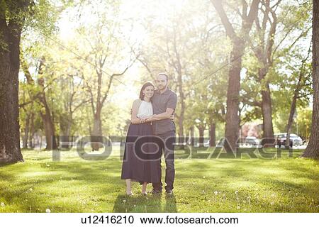 Happy young couple in park View Large Photo Image Stock Image - Happy young couple in park. Fotosearch