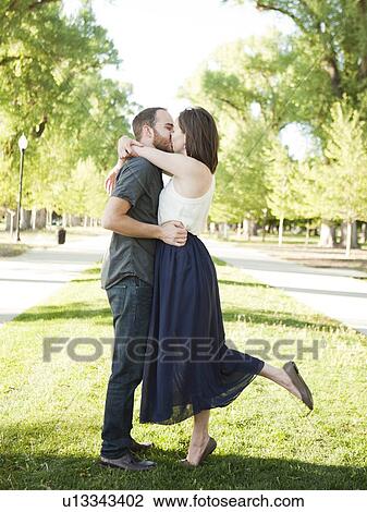 Stock Image - Happy young couple kissing. Fotosearch