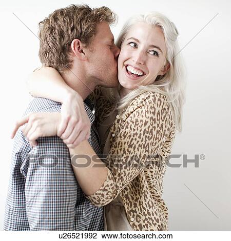 Stock Image - Happy young couple kissing. Fotosearch