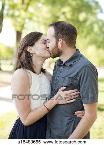 Stock Photography - Happy young couple kissing. Fotosearch