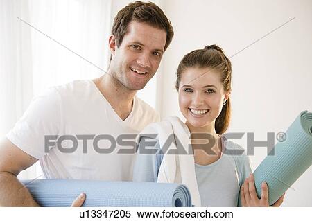 Happy young couple posing with exercising mats View Large Photo Image Stock Photography - Happy young couple posing with exercising mats. Fotosearch