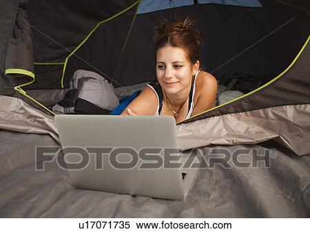 Hiker in tent using laptop View Large Photo Image Stock Photography - Hiker in tent using laptop. Fotosearch