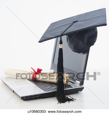 Stock Image - Laptop with diploma and mortar board. Fotosearch