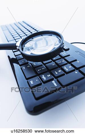 Magnifying glass over computer keyboard View Large Photo Image Stock Image - Magnifying glass over computer keyboard. Fotosearch