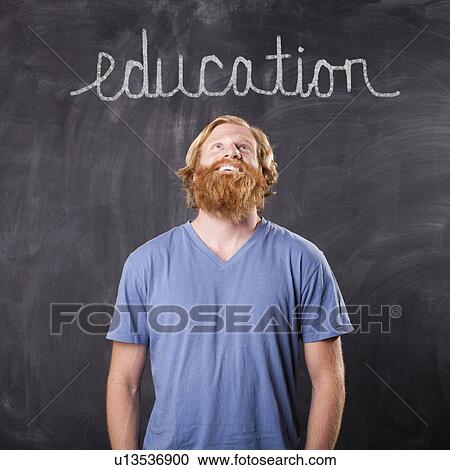 Man in front of blackboard View Large Photo Image Stock Image - Man in front of blackboard. Fotosearch
