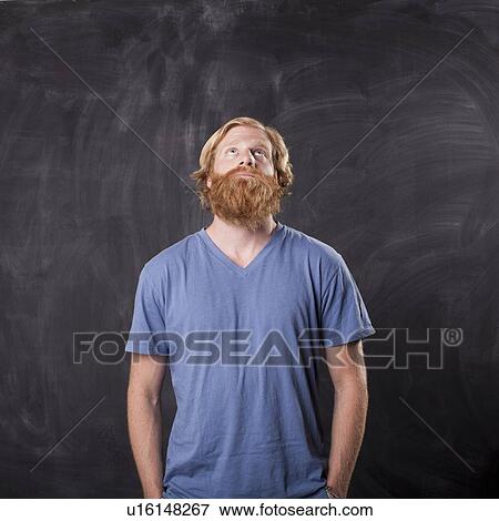 Man in front of blackboard View Large Photo Image Stock Photo - Man in front of blackboard. Fotosearch