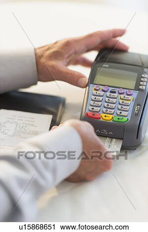 Man inserting credit card in credit card machine View Large Photo Image Stock Image - Man inserting credit card in credit card machine. Fotosearch