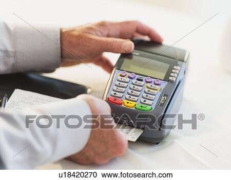 Man inserting credit card in credit card machine View Large Photo Image Stock Image - Man inserting credit card in credit card machine. Fotosearch