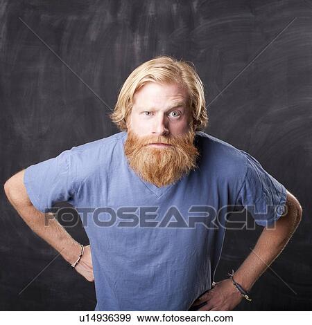Man standing in front of blackboard staring at camera View Large Photo Image Stock Photo - Man standing in front of blackboard staring at camera. Fotosearch