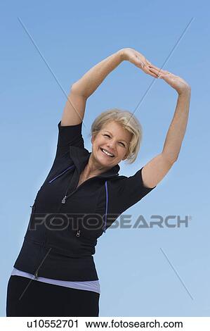 Mature woman exercising outdoors View Large Photo Image Stock Image - Mature woman exercising outdoors. Fotosearch