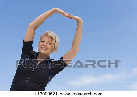 Mature woman exercising outdoors View Large Photo Image Stock Image - Mature woman exercising outdoors. Fotosearch