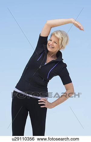 Mature woman exercising outdoors View Large Photo Image Stock Photograph - Mature woman exercising outdoors. Fotosearch