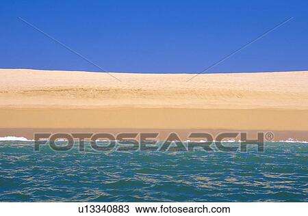 Stock Image - Mexico, Oaxaca, Huatulco, Scenic view of sandy beach. Fotosearch