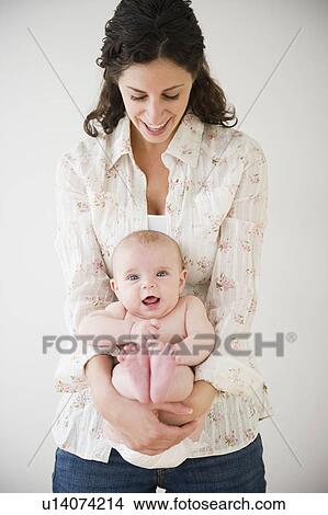 Picture - Mother and baby boy (2-5 months) posing together. Fotosearch