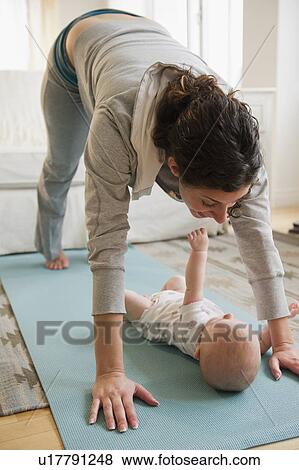 Mother and baby boy (2-5 months) exercising together View Large Photo Image Stock Photo - Mother and baby boy (2-5 months) exercising together. Fotosearch