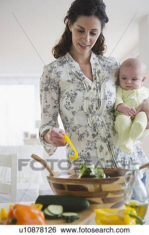Mother and baby boy (2-5 months) cooking together View Large Photo Image Stock Photograph - Mother and baby boy (2-5 months) cooking together. Fotosearch
