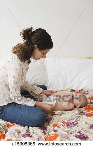 Mother changing baby boy (2-5 months) View Large Photo Image Stock Photography - Mother changing baby boy (2-5 months) . Fotosearch