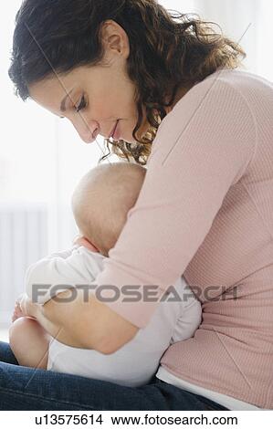Picture - Mother embracing baby boy (2-5 months). Fotosearch