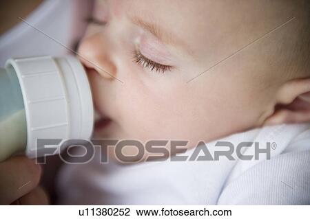 Mother feeding baby boy (2-5 months) using feeding bottle View Large Photo Image Stock Image - Mother feeding baby boy (2-5 months) using feeding bottle. Fotosearch