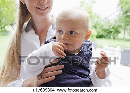 Picture - Mother holding girl . Fotosearch