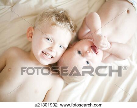 Portrait of boy (2-3) with baby sister (6-11 months) View Large Photo Image Stock Image - Portrait of boy (2-3) with baby sister (6-11 months). Fotosearch