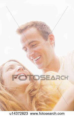 Stock Image - Portrait of couple in sunlight. Fotosearch