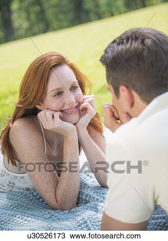 Portrait of couple lying on blanket and smiling View Large Photo Image Stock Image - Portrait of couple lying on blanket and smiling. Fotosearch