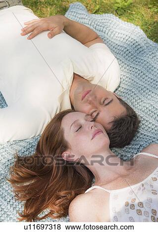 Portrait of couple lying on blanket View Large Photo Image Stock Photo - Portrait of couple lying on blanket. Fotosearch