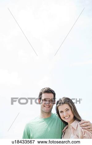Stock Photo - Portrait of happy young couple . Fotosearch