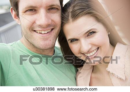 Portrait of happy young couple View Large Photo Image Stock Photo - Portrait of happy young couple . Fotosearch