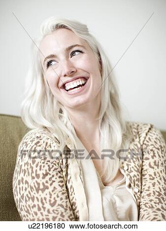 Stock Image - Portrait of laughing young woman. Fotosearch