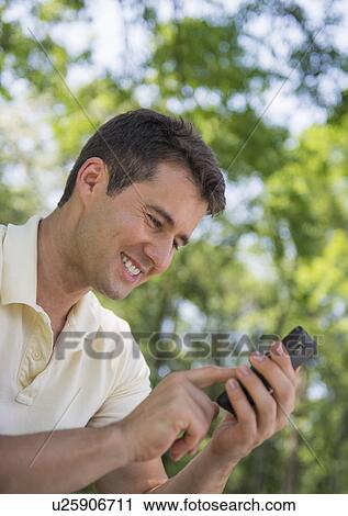 Portrait of man with mobile phone View Large Photo Image Stock Image - Portrait of man with mobile phone. Fotosearch