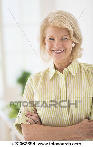 Portrait of mature woman in kitchen View Large Photo Image Picture - Portrait of mature woman in kitchen. Fotosearch