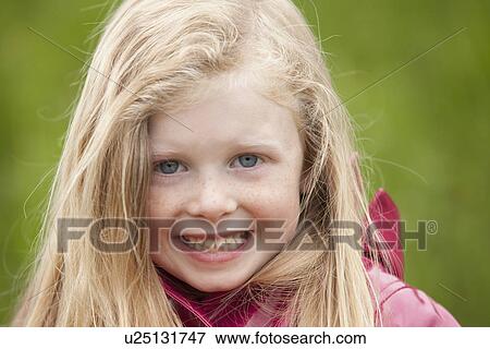 Stock Photo - Portrait of smiling blonde girl. Fotosearch