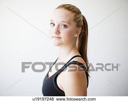 Stock Photo - Portrait of teenage (16-17) gymnast exercising. Fotosearch
