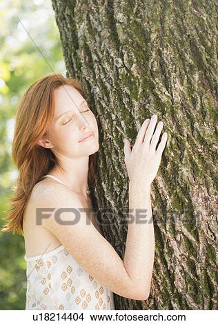Portrait of woman embracing tree View Large Photo Image Picture - Portrait of woman embracing tree. Fotosearch