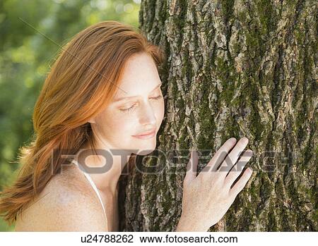 Portrait of woman embracing tree View Large Photo Image Stock Image - Portrait of woman embracing tree. Fotosearch