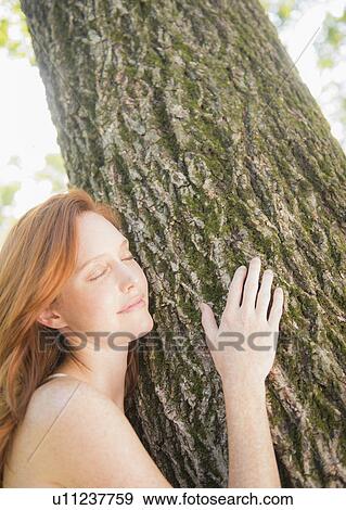 Portrait of woman embracing tree View Large Photo Image Stock Photo - Portrait of woman embracing tree. Fotosearch