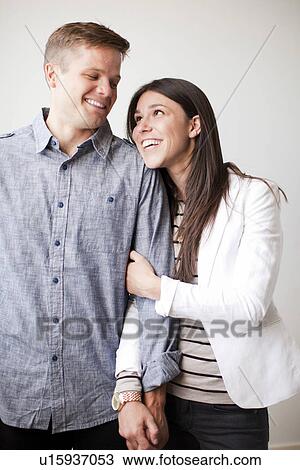 Portrait of young couple, studio shot View Large Photo Image Stock Image - Portrait of young couple, studio shot. Fotosearch
