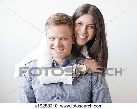 Stock Image - Portrait of young couple, studio shot. Fotosearch