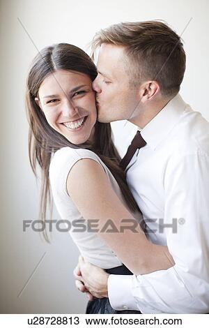 Portrait of young couple, studio shot View Large Photo Image Stock Image - Portrait of young couple, studio shot. Fotosearch