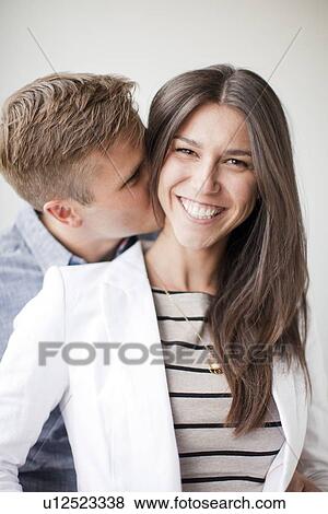 Stock Photo - Portrait of young couple, studio shot. Fotosearch