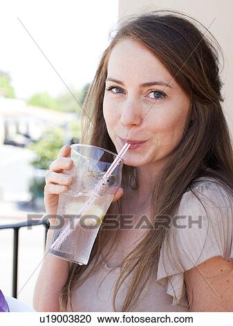 Portrait of young woman drinking water View Large Photo Image Stock Image - Portrait of young woman drinking water. Fotosearch