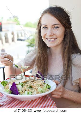 Portrait of young woman having salad View Large Photo Image Stock Image - Portrait of young woman having salad. Fotosearch