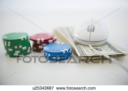 Stock Photo - Roulette tokens, dollar bills and computer mouse. Fotosearch