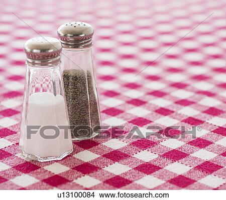 Salt and pepper shakers on checked tablecloth View Large Photo Image Picture - Salt and pepper shakers on checked tablecloth. Fotosearch