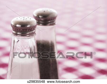 Salt and pepper shakers on checked tablecloth View Large Photo Image Stock Photo - Salt and pepper shakers on checked tablecloth. Fotosearch