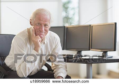 Stock Photograph - Senior professional in office. Fotosearch