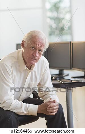 Stock Photography - Senior professional in office. Fotosearch