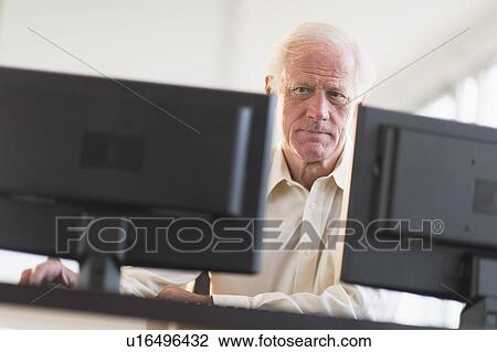 Senior professional working on computer View Large Photo Image Stock Image - Senior professional working on computer. Fotosearch